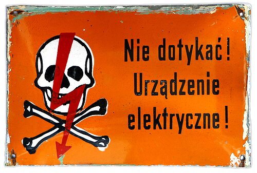 Porcelain Enamel Sign {Poland}, Black lettering and a Red lightning bolt on an Orange background; Landscape orientation and uncommon Orange background!